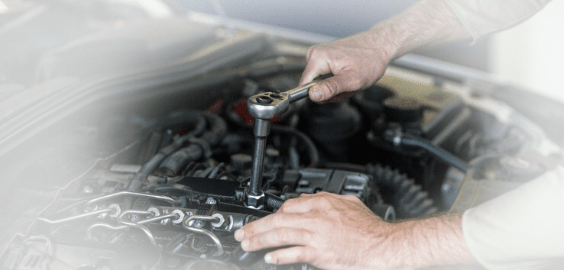 Hands of mechanic servicing a car<br />
