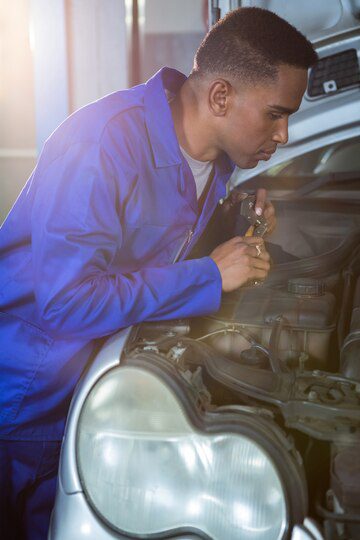 Mechanic examining car<br />
